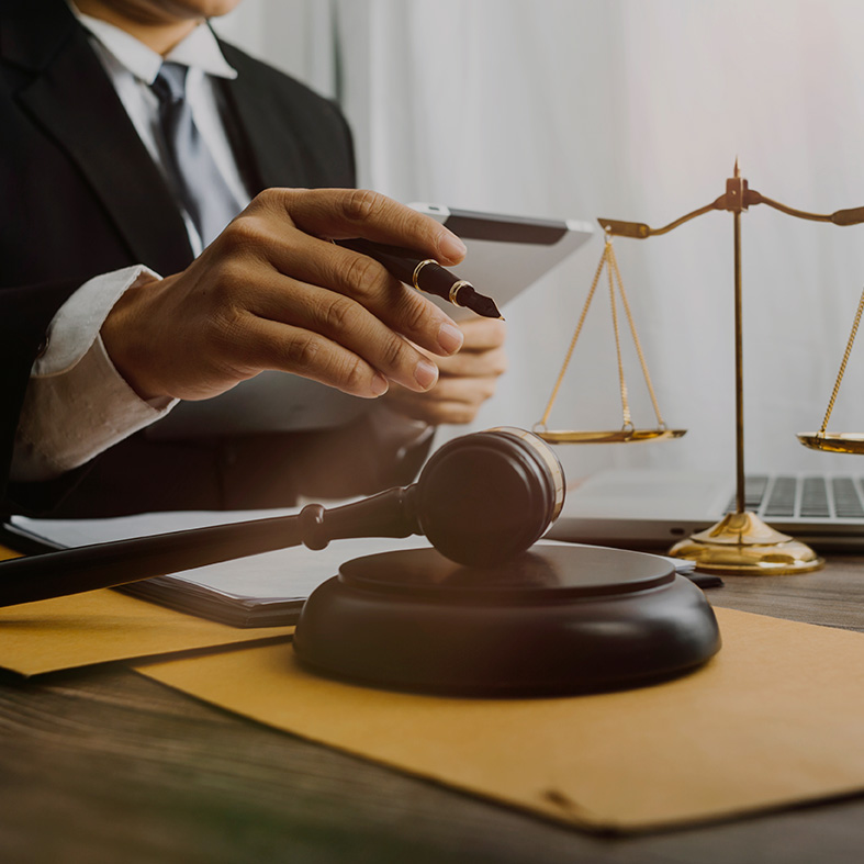 photo of lawyer holding a pen and reading documents
