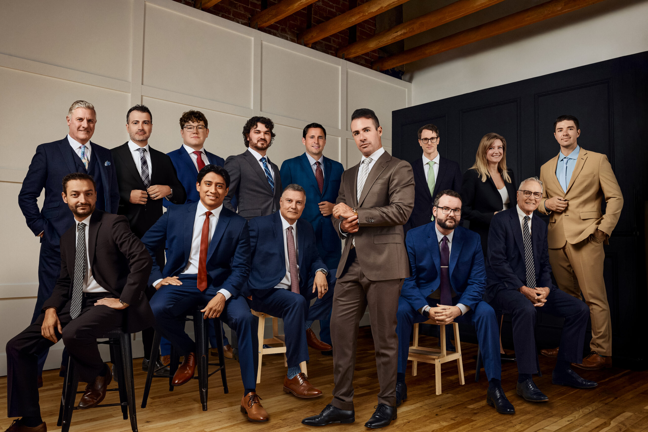 Group portrait of the Shapiro Law team, featuring attorneys and staff dressed in professional business attire, posed together in a modern office studio setting.